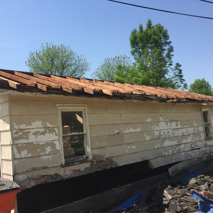 rotten roof torn down to rafters