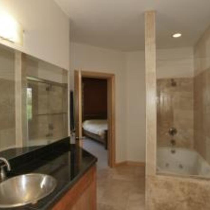 Travertine wrapped jet tub, and floor