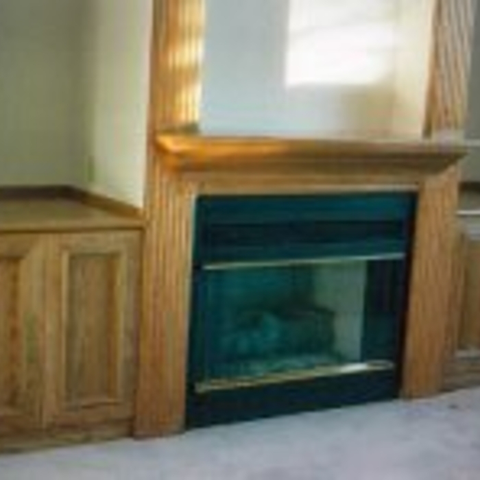 Fire place with side cabinets.