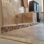 beautiful beige shower with frameless glass door