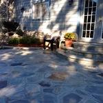 Disappearing waterfall off wall connected to patio