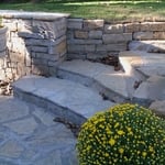 Flagstone patio with flagstone stops up wall