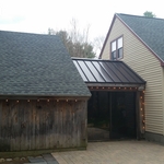 Asphalt roof with metal roof accent