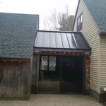 Asphalt roof with metal roof accent