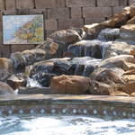 a close up view of an impressive water feature beside pool
