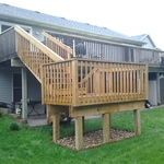 Wood staircase and alnding off of the deck
