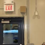 Power supply encloser piped into door frame