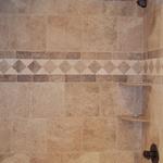 Shower with travertine mosaic band and porcelain
