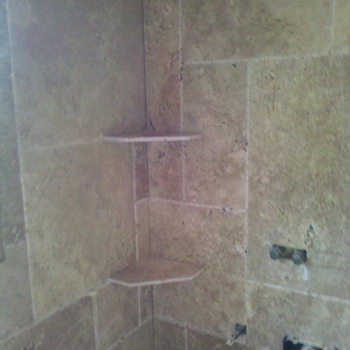 construction phase of a natural stone tiled shower