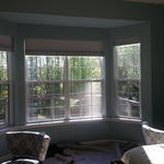 a white trimmed bay window with blue walls