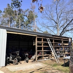 Installing new metal on large pole barn after repa