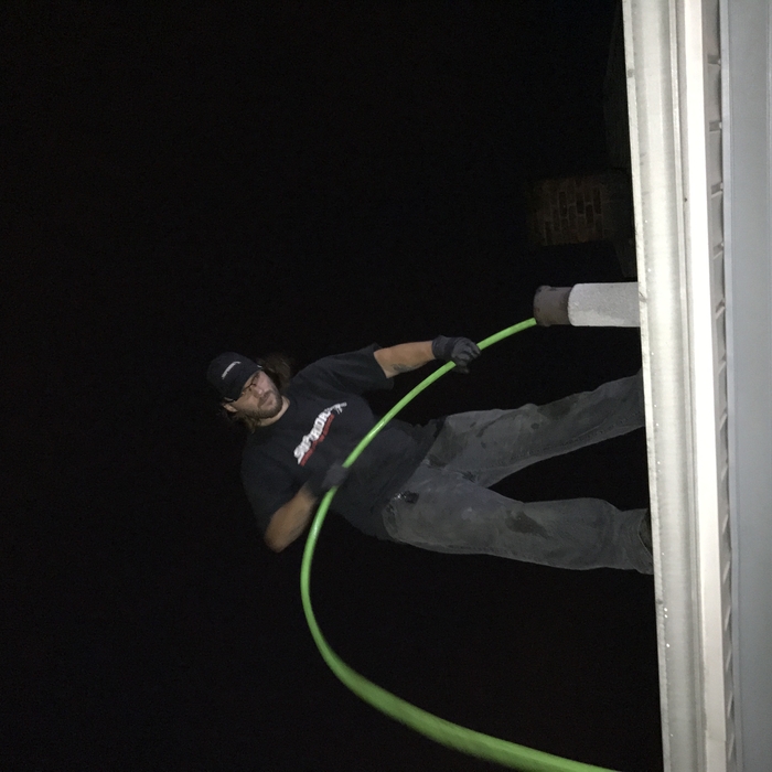 Jetting a sewer line from a roof vent