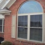 beautiful red brick house with arched clerestory window