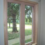 Unstained wood clad custom built casement windows.