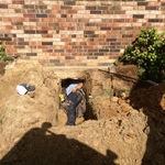 Repairing a leak in copper pipe under a house.