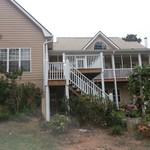 Back of the house with a screened-in porch and a deck
