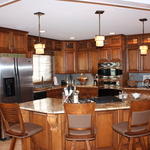 Curved island with breakfast bar and corbels