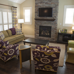 transitional living room with purple floral arm chairs