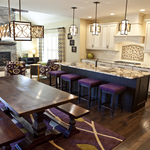 This beautiful kitchen has glazed cabinets, granite counter tops , and lovely tile work combining cream and purple in a striking way making a relaxed but efficient kitchen.