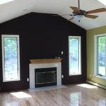Living room with fireplace and high ceiling
