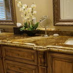 a traditional style master bathroom with a his and hers sink and beige granite countertop