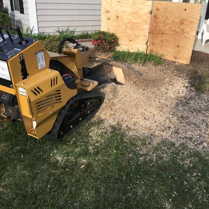 Stump grinding with protective barrier