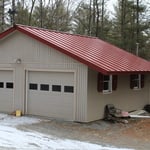 Garage with new roof, extended eves, and siding