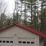 Garage with new roof, extended eves, and siding