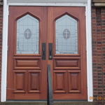 a french door entry with custom fit windows and wrought iron door handles