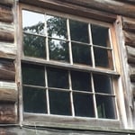 Log cabin with divided light window