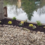 built flower bed, stone walkway and mulched