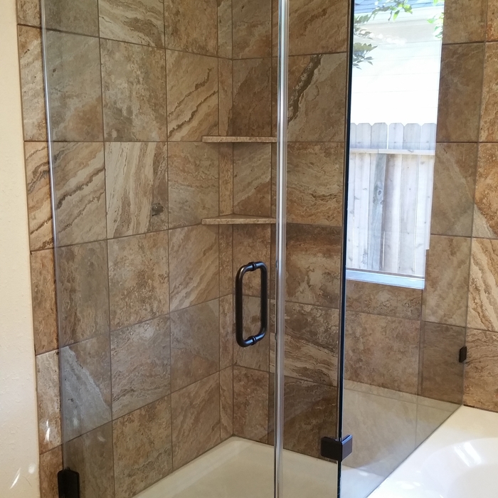 Frameless shower enclosure