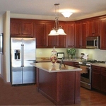 Kitchen remodel with raised panel cabinetry, stainless steel appliances and a small kitchen island