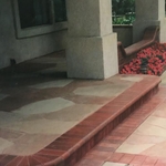 stamped concrete porch with red brick border