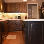 Old world finishes with black distressed island.