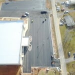 Close to the end of asphalt parking lot.