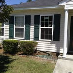 Charming white house with black shutters.