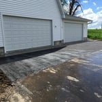 Spacious garage with two garage doors.