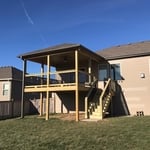 Treated deck with hip roof cover.