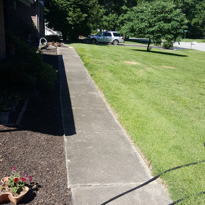 Power washing sidewalk