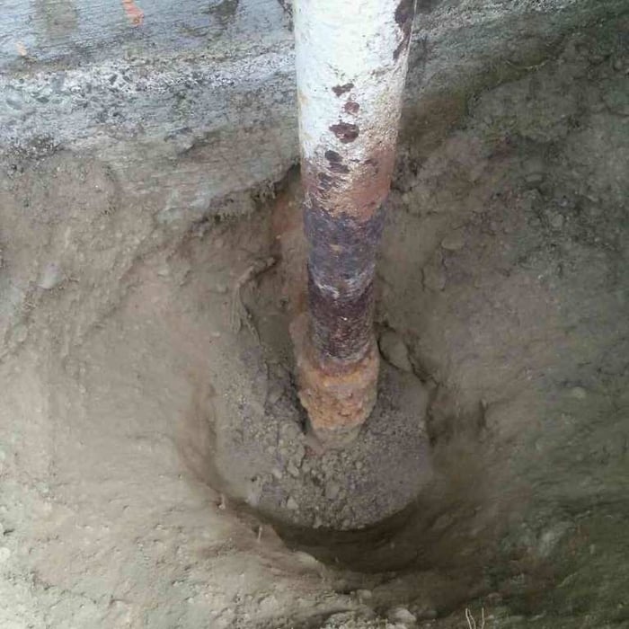 old rusted gas line goes to crawl space