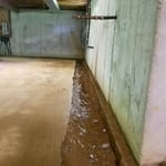 A trench is jackhammered from the slab