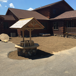 Charming wishing well as centerpiece of yard and patio.