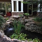pOND WITH wATERFALL
