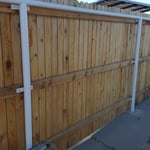 pipe fence with wood panels