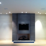 TV in a recessed pocket with ceiling speakers.