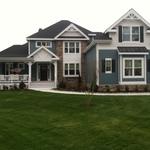 lovely cape cod home with blue siding and white trim