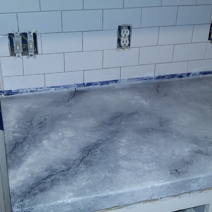concrete countertops and tile backsplash