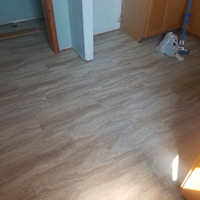 Putting in the new laminated flooring.