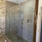 Frameless shower enclosure